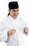 Smiling Chef holding fork and knife Stock Photo