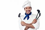 Smiling Chef Holding Kitchenware Stock Photo