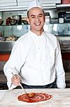 Smiling Chef Making Pizza Stock Photo