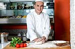 Smiling Chef Preparing Pizza Base Stock Photo