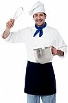 Smiling Chef Showing Kitchen Essentials Stock Photo