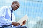 Smiling Corporate Executive Using A Tablet Pc Stock Photo