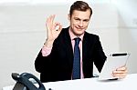 Smiling Corporate Male Showing Ok Sign Stock Photo