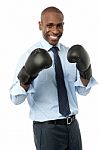 Smiling Corporate Man Wearing Boxing Gloves Stock Photo