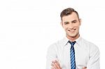 Smiling Corporate Man With Folded Arms Stock Photo