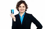 Smiling Corporate Woman Holding Credit Card Stock Photo