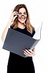 Smiling Corporate Woman Holding Open Folder Stock Photo