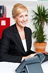 Smiling Corporate Woman In Office Stock Photo