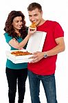 Smiling Couple Eating Pizza Stock Photo