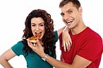 Smiling Couple Eating Pizza Stock Photo