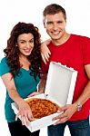 Smiling Couple Holding Pizza Box Stock Photo