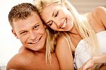 Smiling Couple In Bed Stock Photo