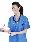 Smiling Cute Nurse Making Her Medical Notes Stock Photo