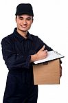 Smiling Delivery Man At Your Doorstep Stock Photo