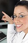 Smiling Doctor Pointing Desktop Stock Photo