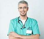 Smiling Doctor With His Arms Crossed Stock Photo