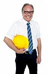 Smiling Experienced Architect Posing With Safety Helmet Stock Photo