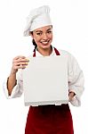 Smiling Female Chef Opening Pizza Box Stock Photo