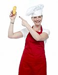 Smiling Female Cook Pointing Bread Stock Photo