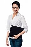 Smiling Female Executive Holding Business Files Stock Photo