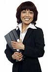 Smiling Female Holding Binder Stock Photo