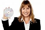 Smiling Female Manager Showing Compact Disc Stock Photo