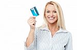 Smiling Female Model Holding Up Credit Card Stock Photo