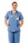 Smiling Female Nurse Standing With Stethoscope Stock Photo