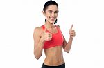 Smiling Fit Woman Gesturing Double Thumbs Up Stock Photo