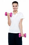 Smiling Fitness Teenage Girl Lifting Weights Stock Photo