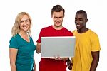 Smiling Friends Using Laptop Stock Photo