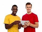 Smiling Friends Using Tablet Pc Stock Photo