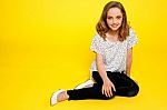 Smiling Girl Sitting On Floor Stock Photo