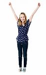 Smiling Girl With Raised Arms Stock Photo