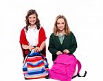 Smiling Girls Unzipping School Bag Stock Photo