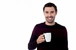 Smiling Guy Enjoying Refreshing Coffee Stock Photo