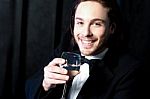 Smiling Guy In Tuxedo Drinking Cocktail Stock Photo