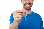 Smiling Guy Offering House Key Stock Photo