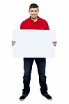 Smiling Guy Presenting Blank Board Stock Photo