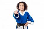 Smiling Karate Girl Pointing Towards You Stock Photo