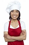 Smiling Lady Chef With Arms Crossed Stock Photo