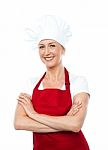 Smiling Lady Chef With Crossed Arms Stock Photo