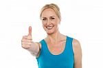 Smiling Lady Showing Thumbs Up Stock Photo