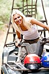 Smiling Lady Standing On Quad Bike Stock Photo