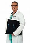 Smiling Male Doctor Holding X Ray Stock Photo