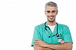 Smiling Male Doctor With Arms Crossed Stock Photo