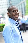 Smiling Male Executive Posing In Street Stock Photo