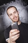 Smiling Male Holding Smartphone Stock Photo