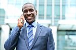 Smiling Male Professional Talking On Cell Phone Stock Photo