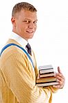 Smiling Male Student Holding Books Stock Photo